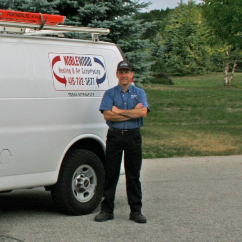 Alan standing beside Noblewood vehicle